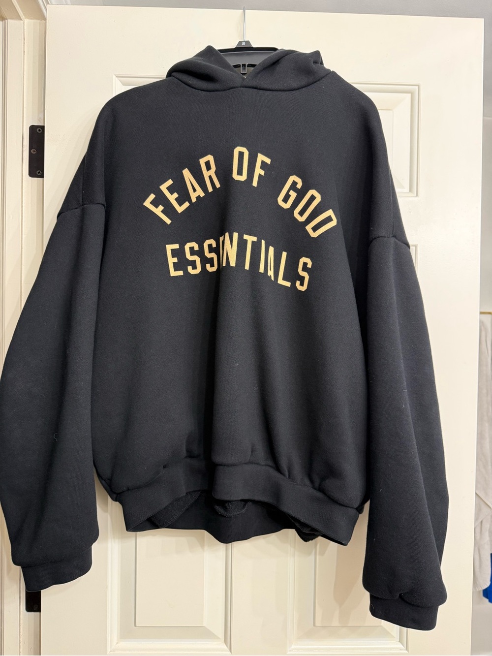 Fear of God Essentials Black Hoodie with Tan Logo Arch